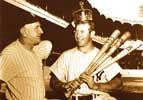 Casey Stengel crowns Mickey Mantle with the "Sultan of Swat" award crown after Mickey won baseball's Triple Crown in 1956 - Mickey holds three bats labeled with his major-league leading Triple Crown statistics: 52 home runs, 130 runs-batted-in (rbi) and .353 batting average
