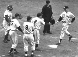 Mickey Mantle is greeted by temmates after belting a left-handed grand slam home run into the left-centerfield upper deck at Ebbets Field against the Brooklyn Dodgers in Game 5 of the 1953 World Series